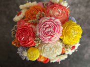 Colorful bouquet of wax flowers on a dark background