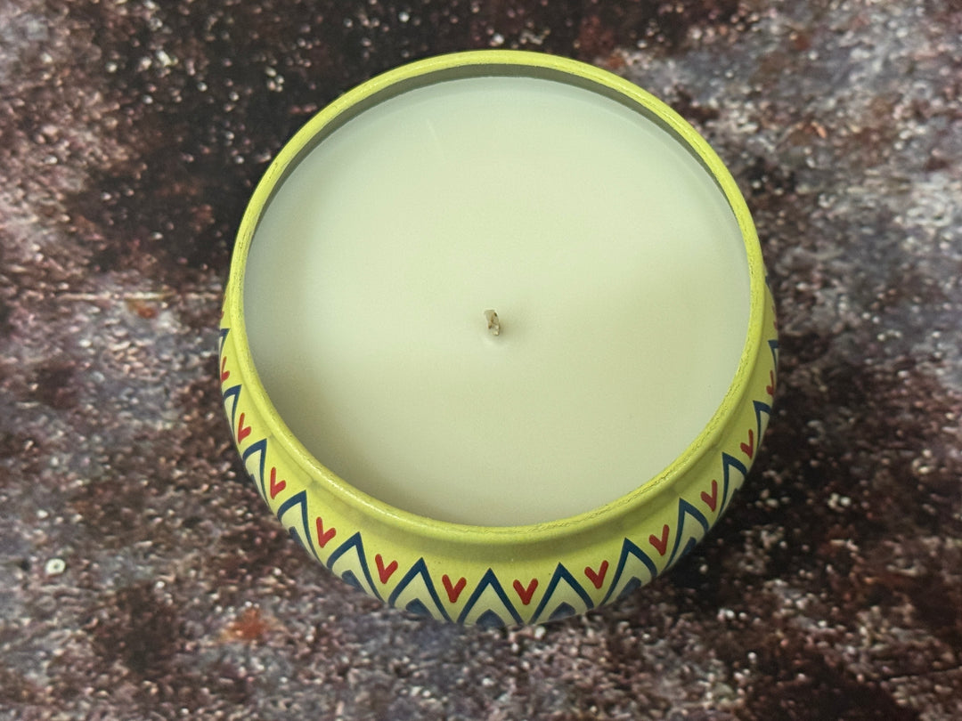 Candle in a decorative moroccan container on a textured surface