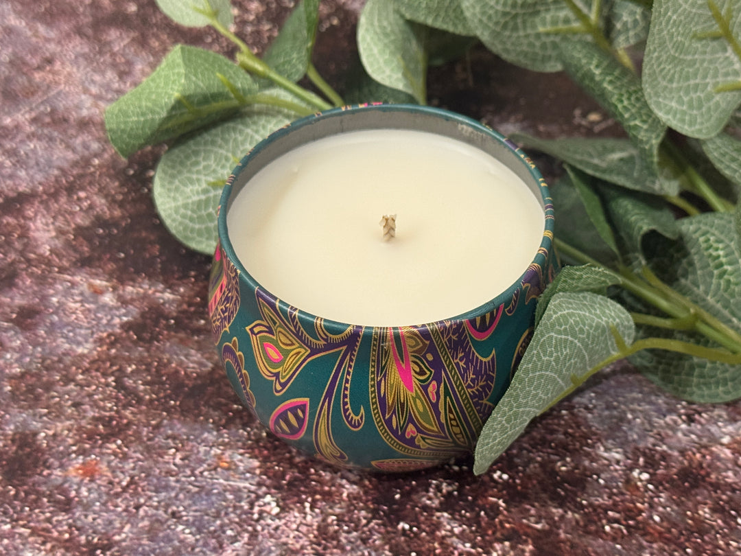 Smooth surfaced Candle in a decorative tin.