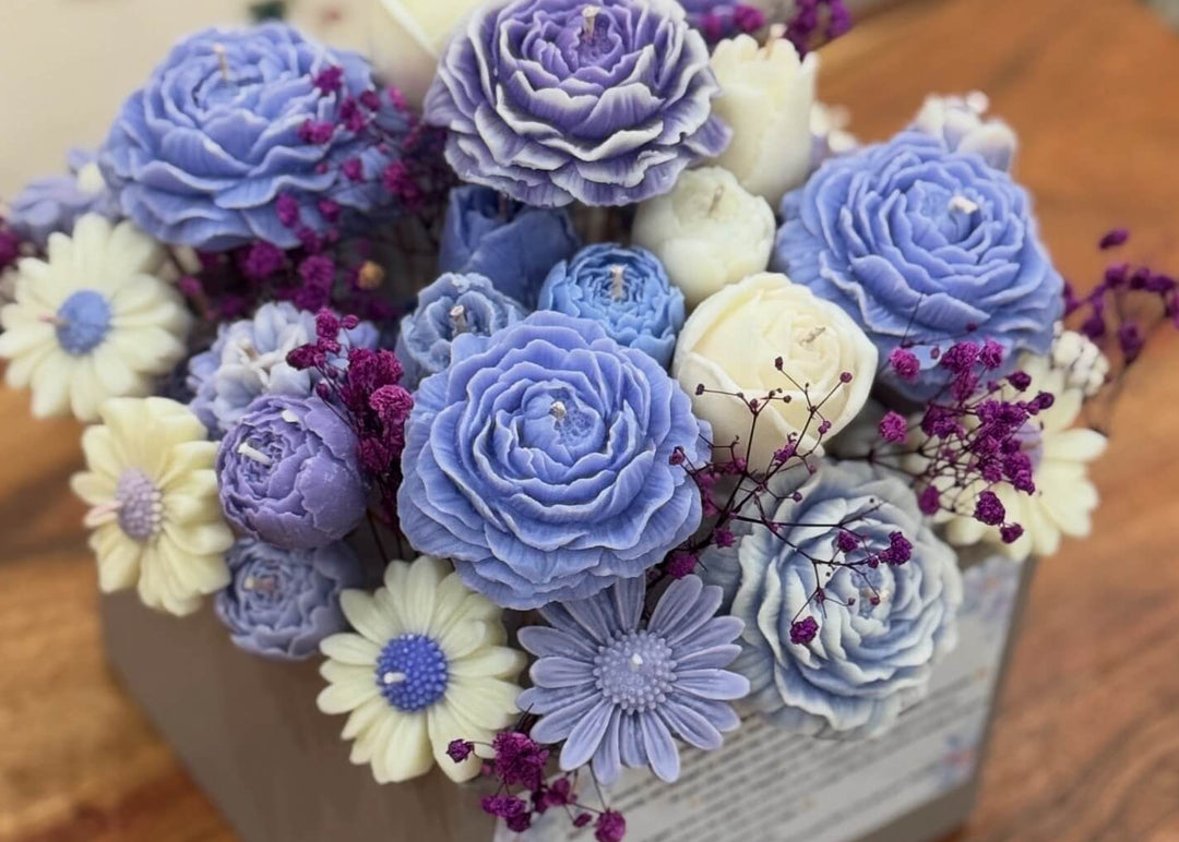 Bouquet of blue, purple, and white flowers in a box 