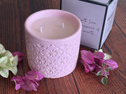 Hand-poured soy wax candle inside modern concrete jar in pastel pink
