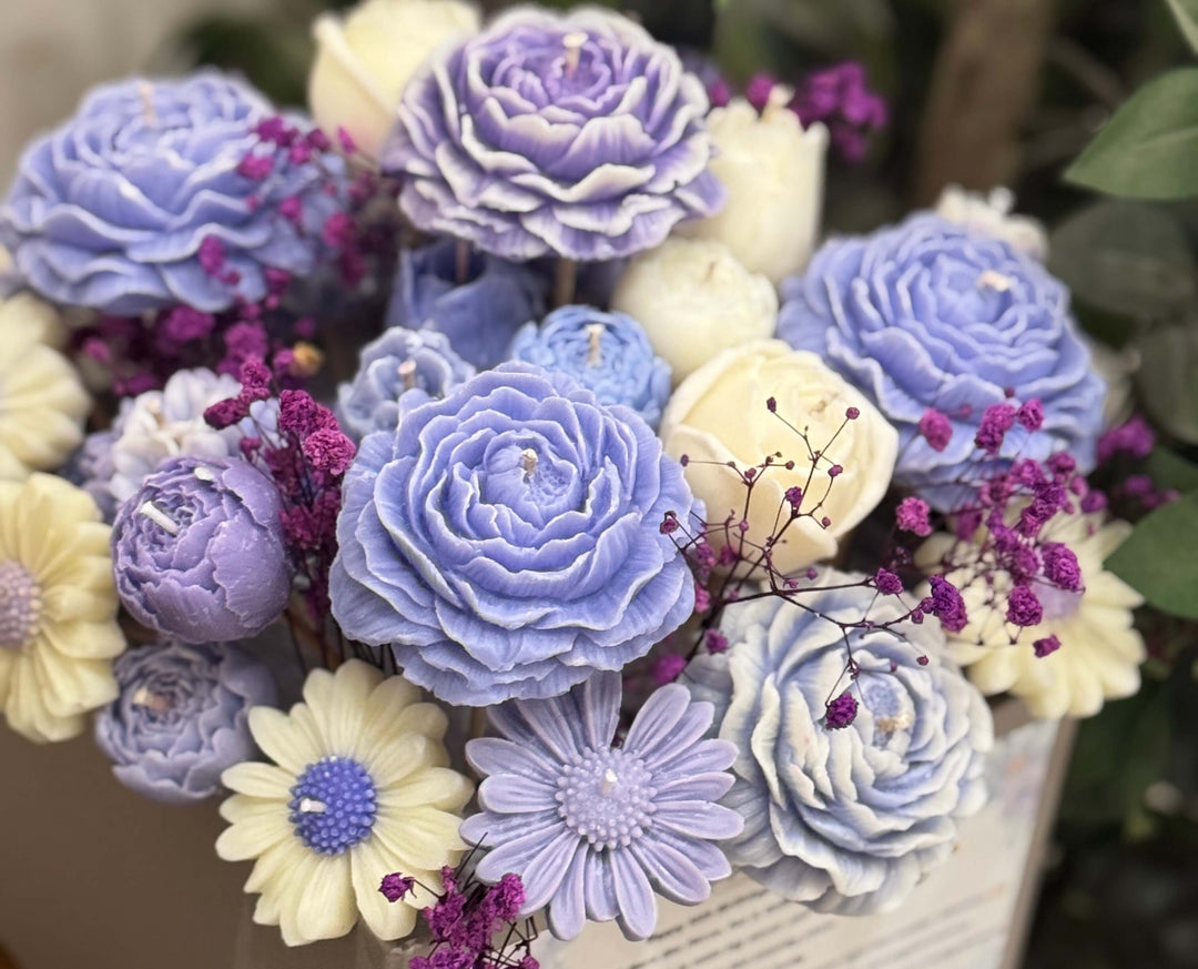 Bouquet of decorative flowers in shades of blue, purple, and white.