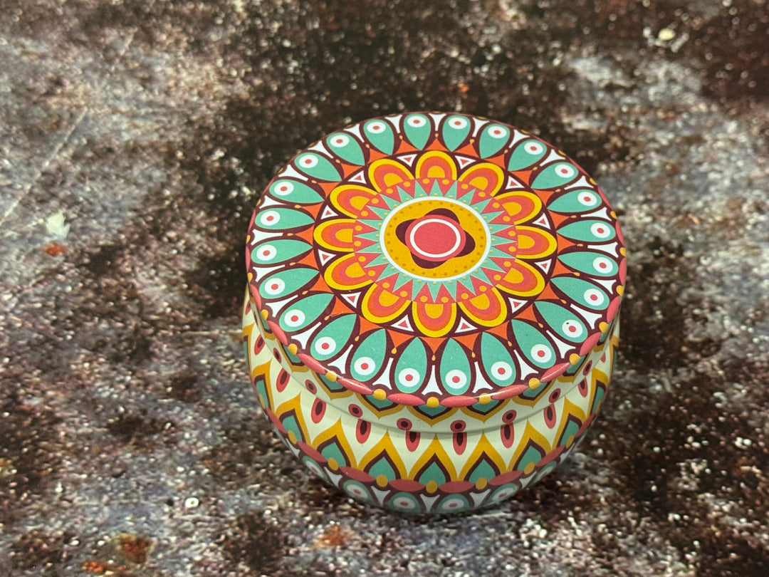 Decorative colourful round moroccan tin candle with lid decorated with intricate patterns 
