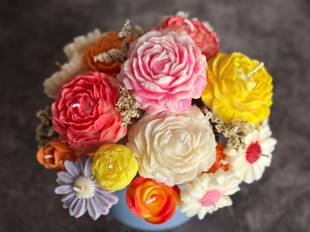 Colourful bouquet of wax flowers on a dark background