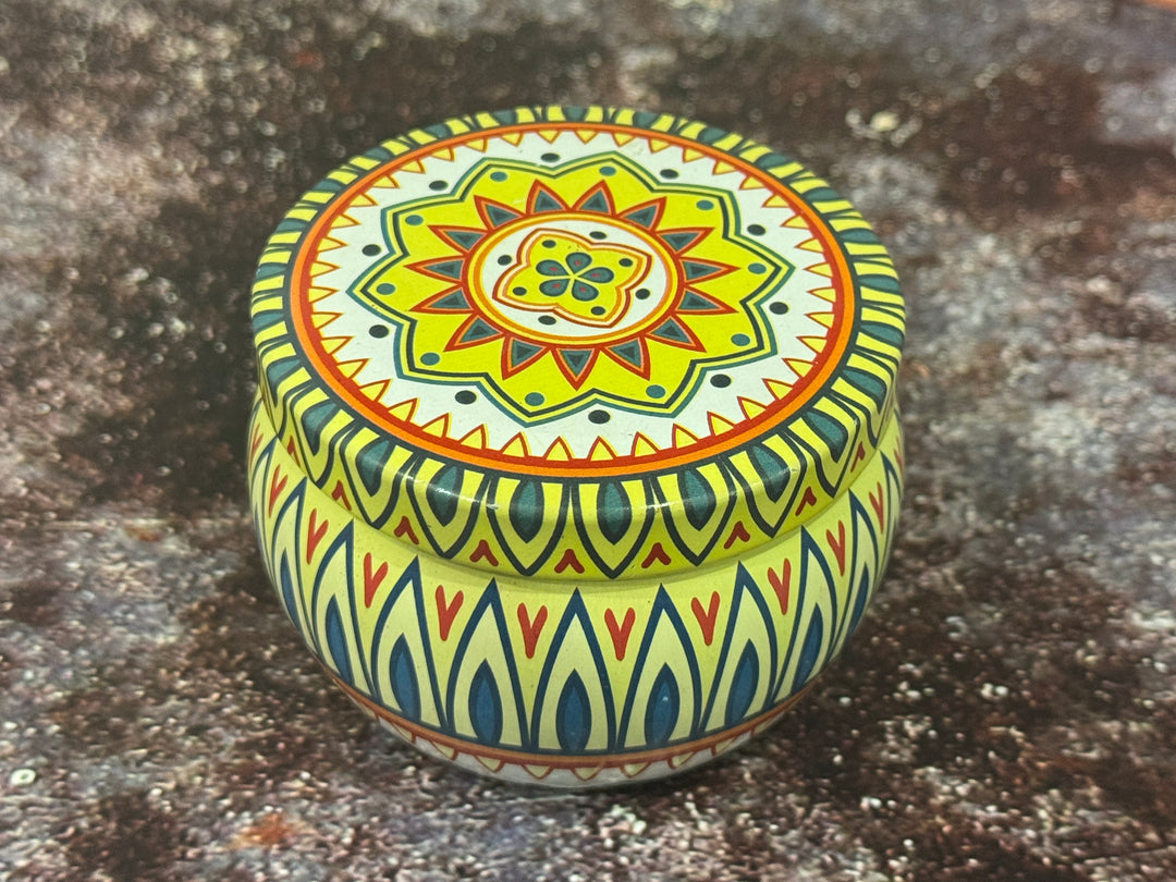Decorative moroccan tin jar candle with intricate patterns on a textured surface